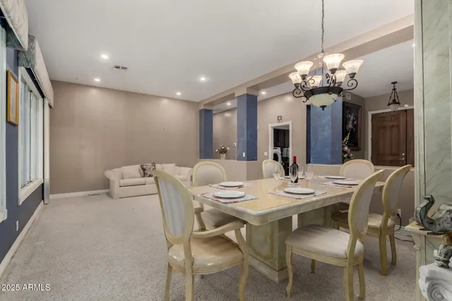 a view of a dining room with furniture and a chandelier