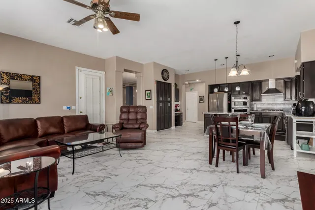 a living room with furniture a dining table and a rug