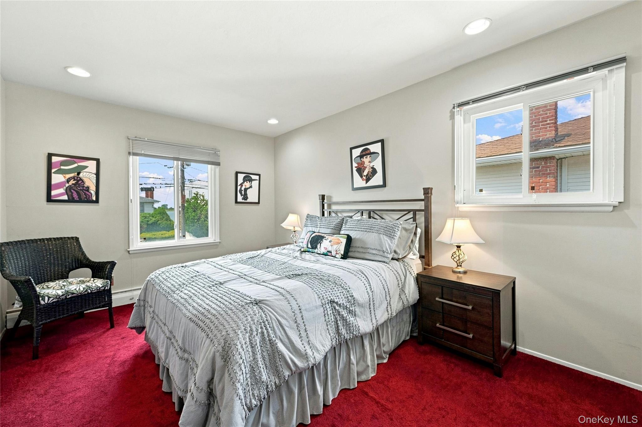 3165 Clubhouse Road Merrick, NY 11566 - Photo 29 of 45 Recessed ceiling lighting, two windows with blinds, wood-finish nightstand, and a metal bed frame