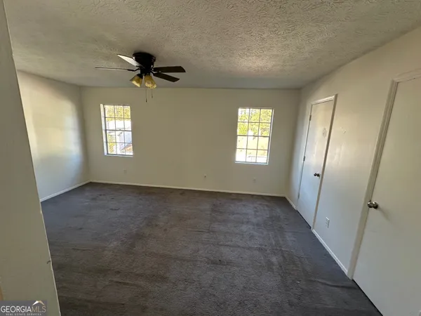 an empty room that has a window in it