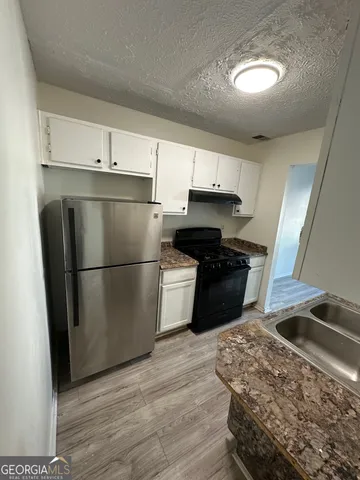 a kitchen with wooden floors and a stove