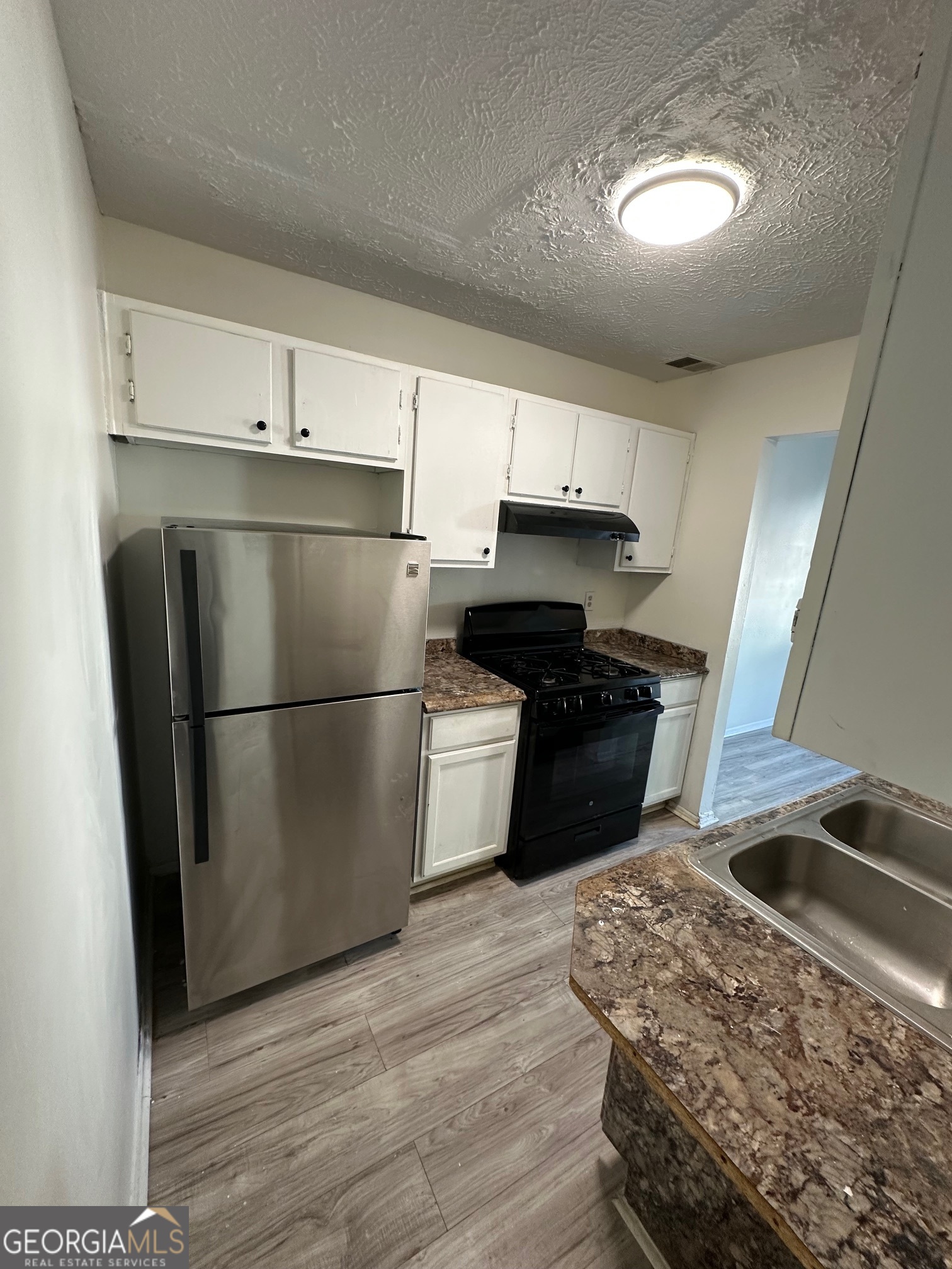 2511 Pine Tree Trail South Fulton, GA 30349 - Photo 7 of 23 a kitchen with a refrigerator sink and stove