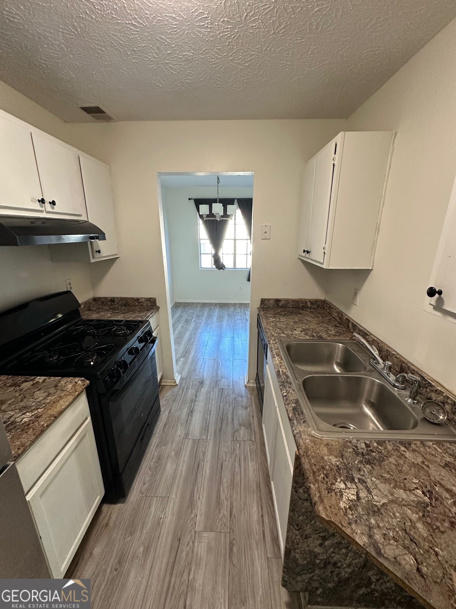 2511 Pine Tree Trail South Fulton, GA 30349 - Photo 8 of 23 a kitchen with wooden floors and a stove