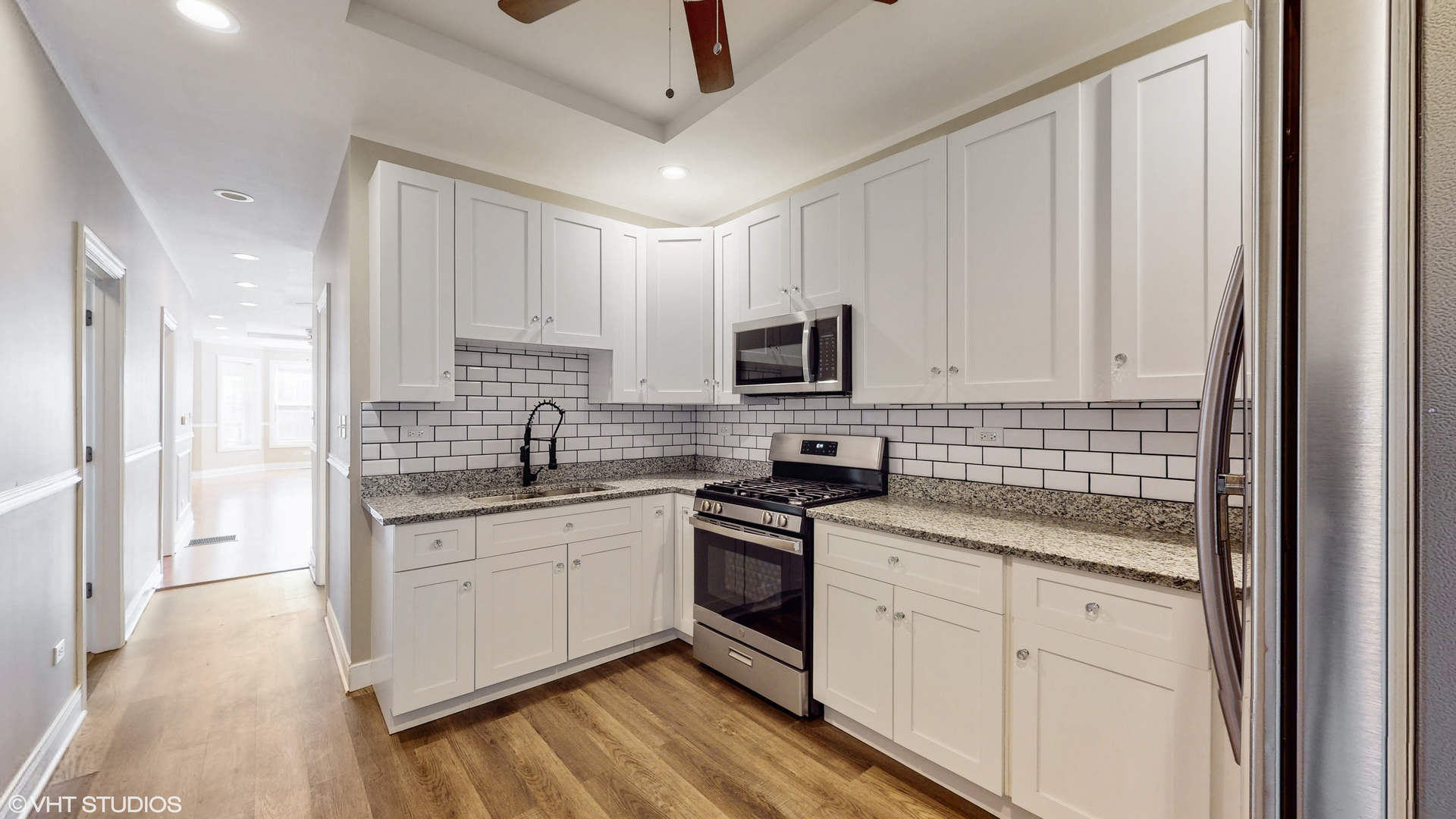 7316 South Peoria Street Chicago, IL 60621 - Photo 7 of 40 a kitchen with white cabinets and appliances