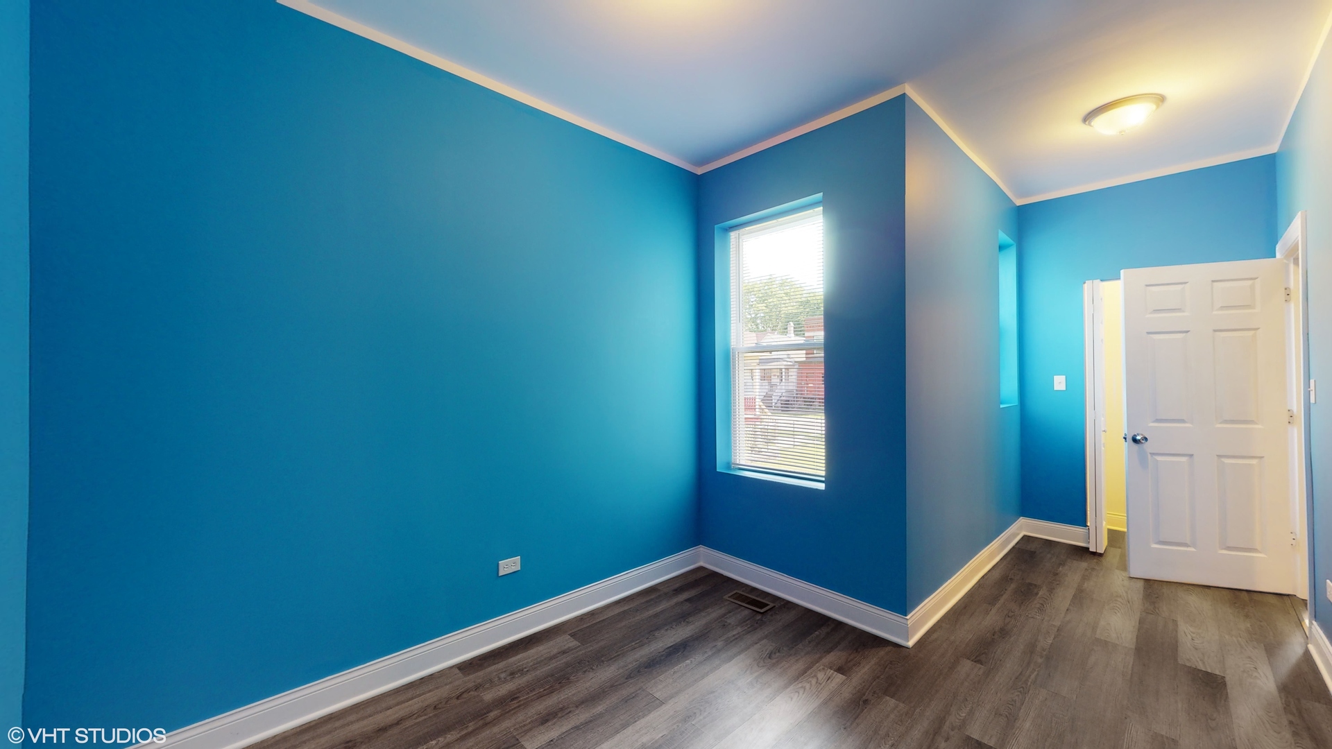 7316 South Peoria Street Chicago, IL 60621 - Photo 10 of 40 a view of empty room with window and wooden floor