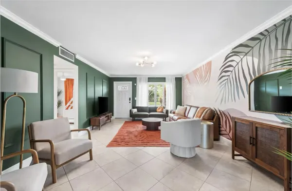 a kitchen with granite countertop white cabinets and stainless steel appliances