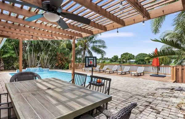 a view of a house with backyard and sitting area