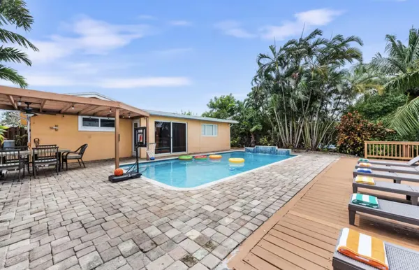 a view of a swimming pool with lounge chairs