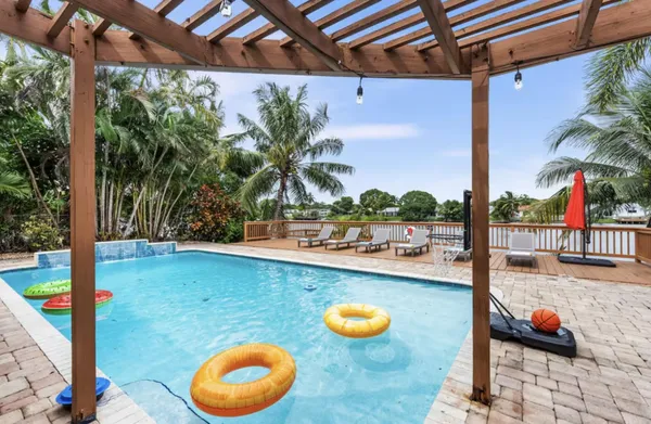 a view of a house with swimming pool and sitting area