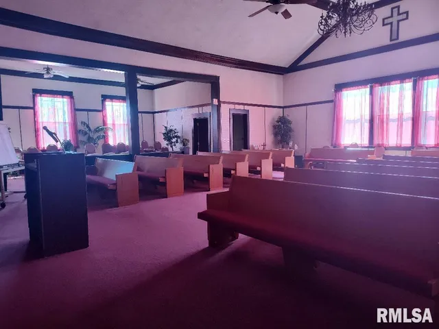 a living room with lots of furniture and chandelier