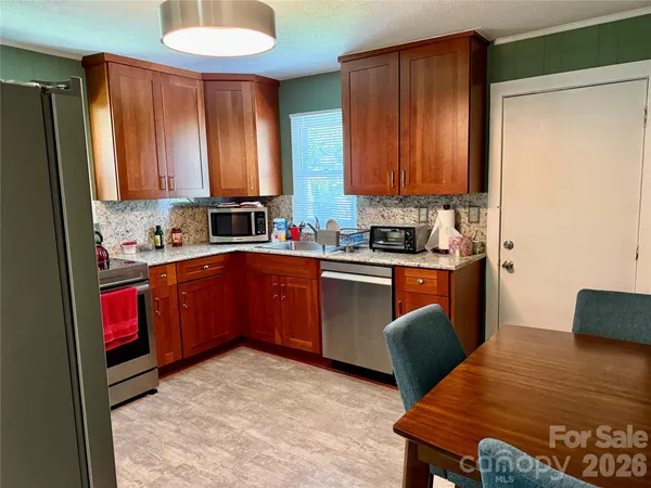 a kitchen with a sink appliances and cabinets