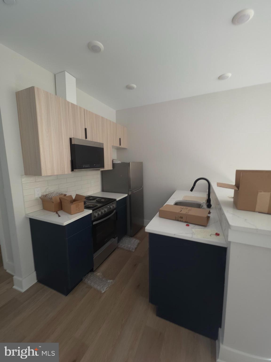 3503 Midvale Avenue, Unit 503 Philadelphia, PA 19129 - Photo 25 of 29 a kitchen with stainless steel appliances granite countertop a sink stove and refrigerator
