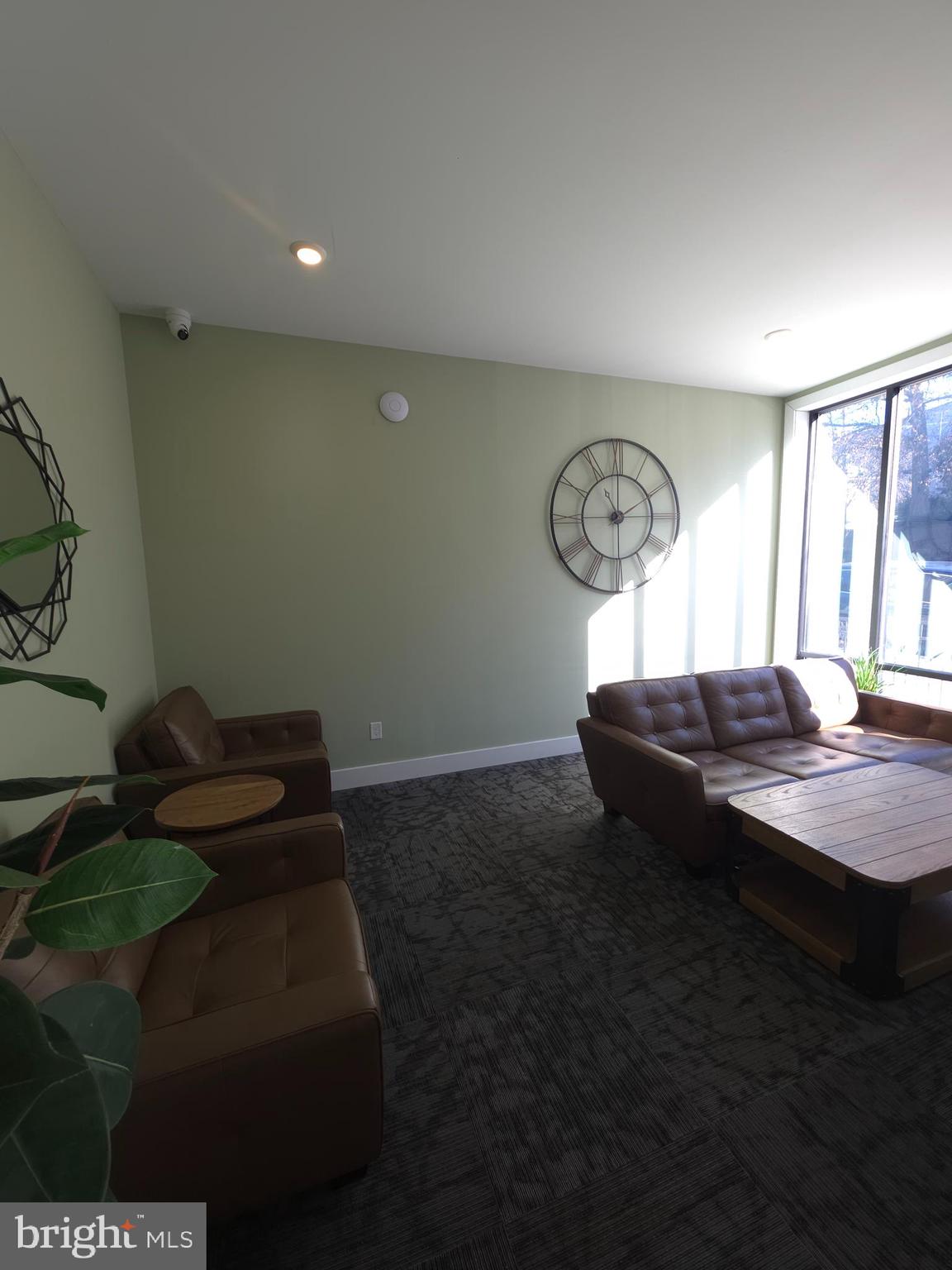3503 Midvale Avenue, Unit 503 Philadelphia, PA 19129 - Photo 4 of 29 a living room with a table chairs and a window