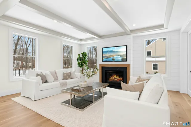 a living room with furniture and view of kitchen