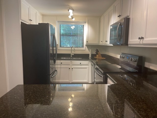 637 Riverside Drive Ellijay, GA 30540 - Photo 3 of 17 a kitchen with a sink a stove and refrigerator