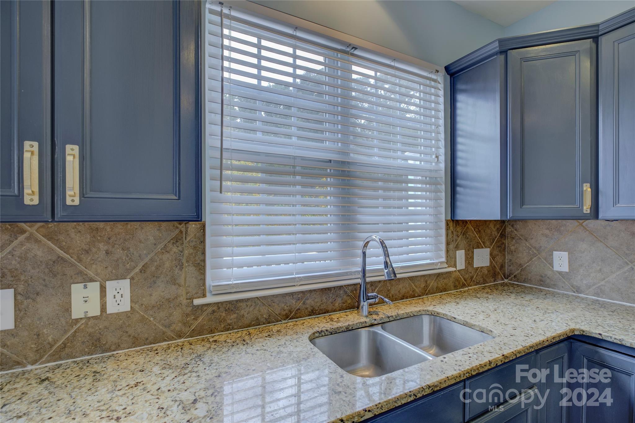 568 6th Baxter Crossing Fort Mill, SC 29708 - Photo 14 of 48 a kitchen with a sink cabinets and granite counter top
