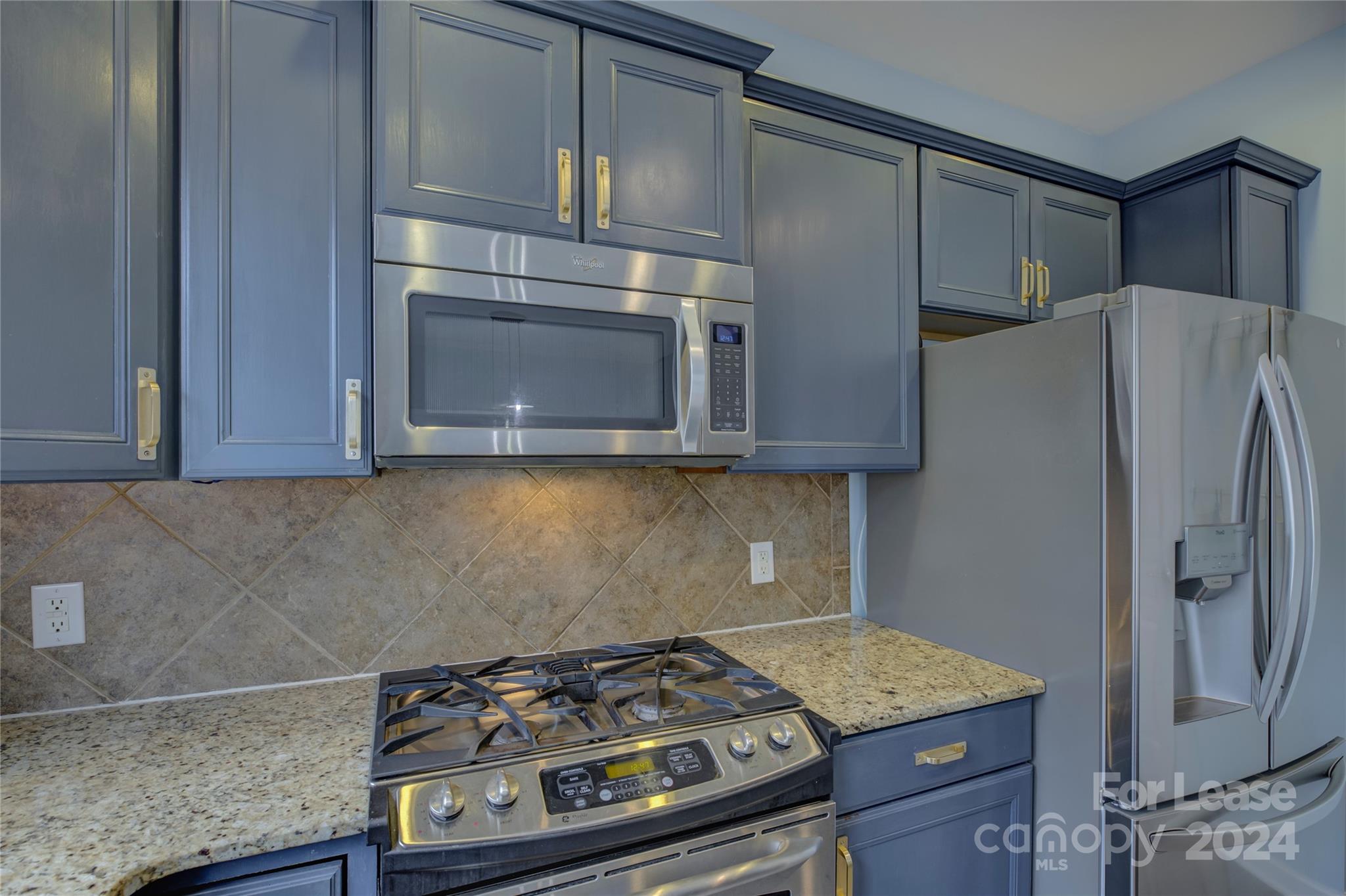 568 6th Baxter Crossing Fort Mill, SC 29708 - Photo 15 of 48 a kitchen with stainless steel appliances granite countertop a stove and a microwave