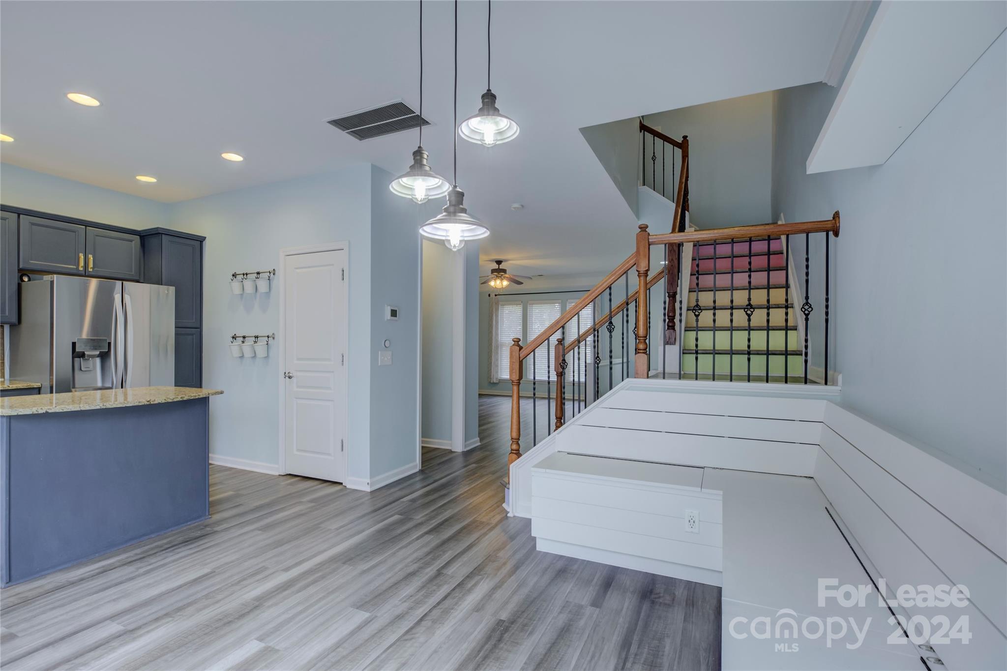 568 6th Baxter Crossing Fort Mill, SC 29708 - Photo 18 of 48 a hallway with wooden floor windows and kitchen view
