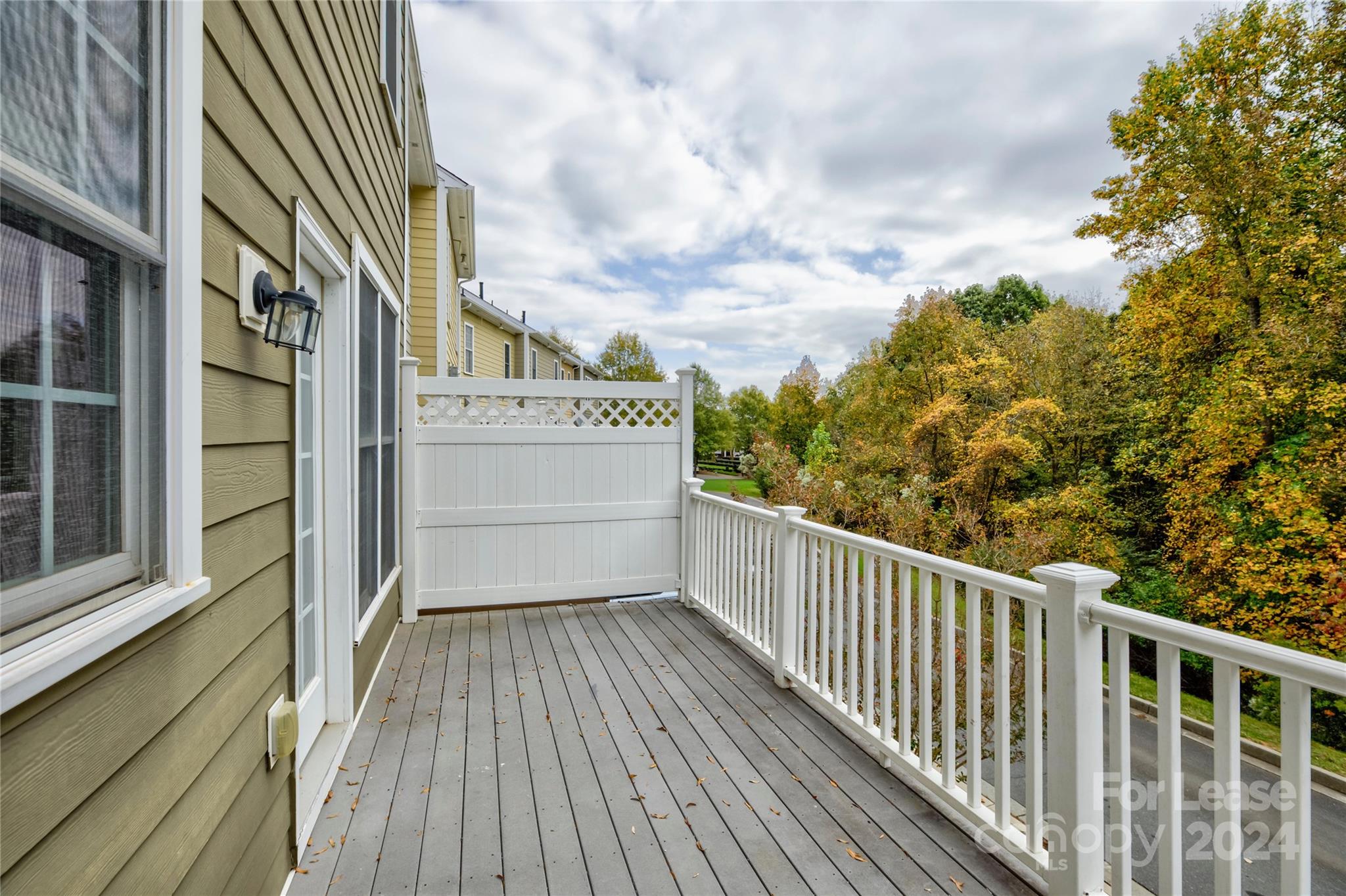 568 6th Baxter Crossing Fort Mill, SC 29708 - Photo 22 of 48 a view of a balcony with wooden floor and fence