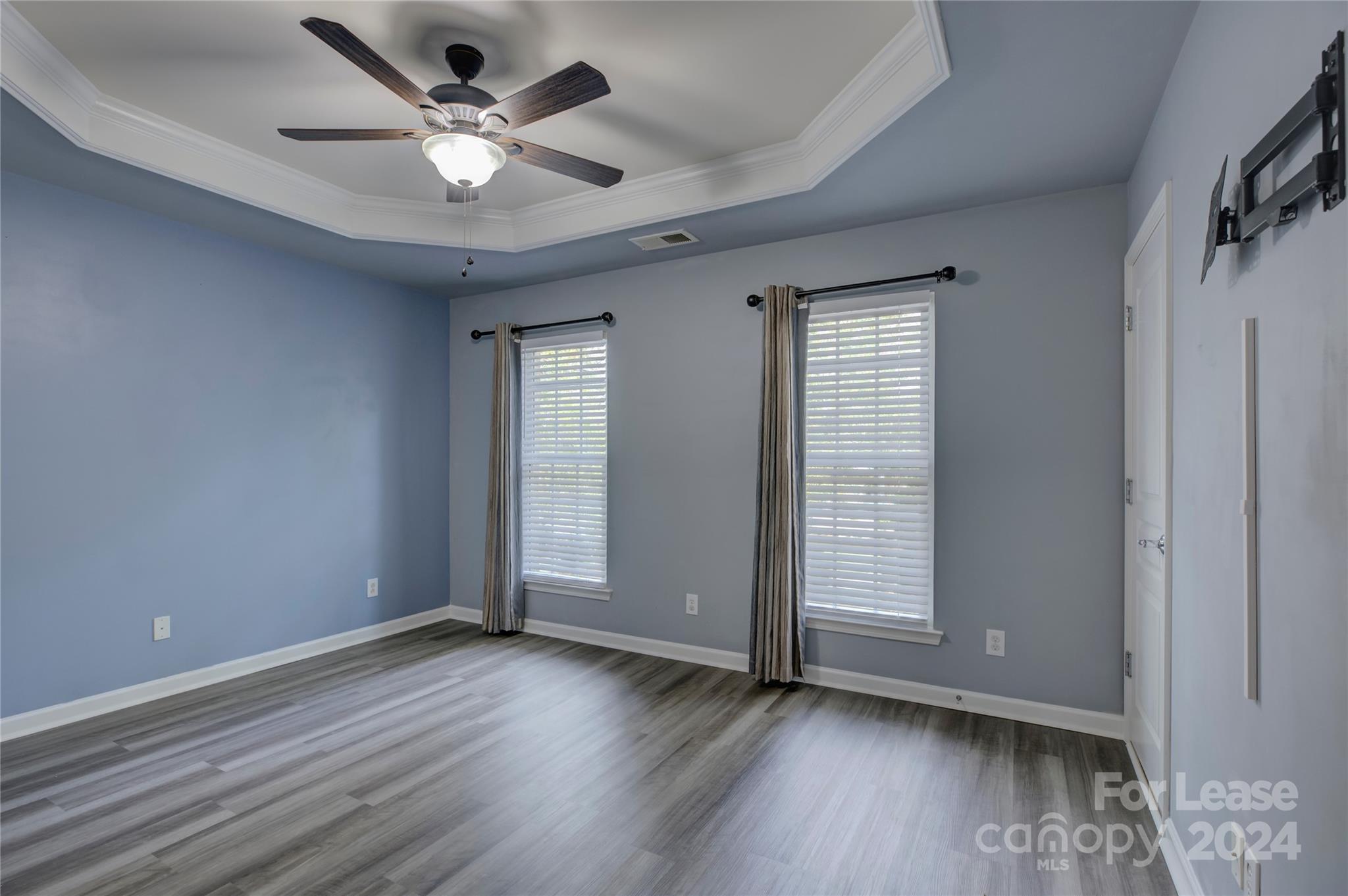 568 6th Baxter Crossing Fort Mill, SC 29708 - Photo 25 of 48 an empty room with wooden floor and ceiling fan