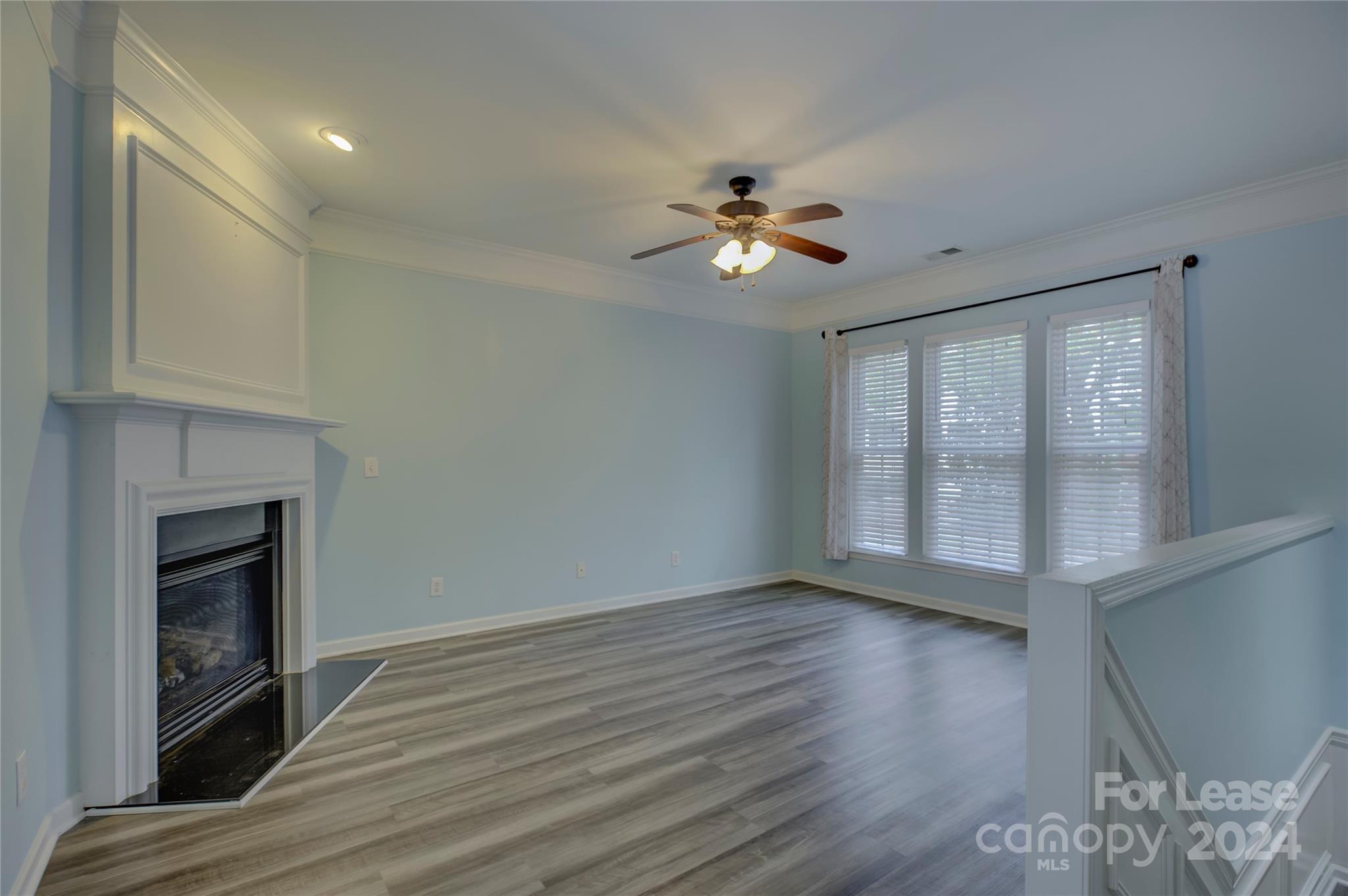 568 6th Baxter Crossing Fort Mill, SC 29708 - Photo 5 of 48 a view of empty room with wooden floor and fireplace