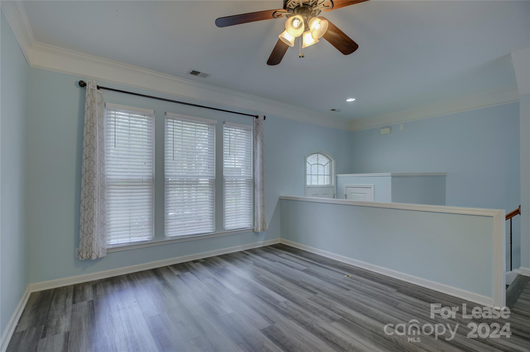568 6th Baxter Crossing Fort Mill, SC 29708 - Photo 6 of 48 a view of empty room with wooden floor and fan