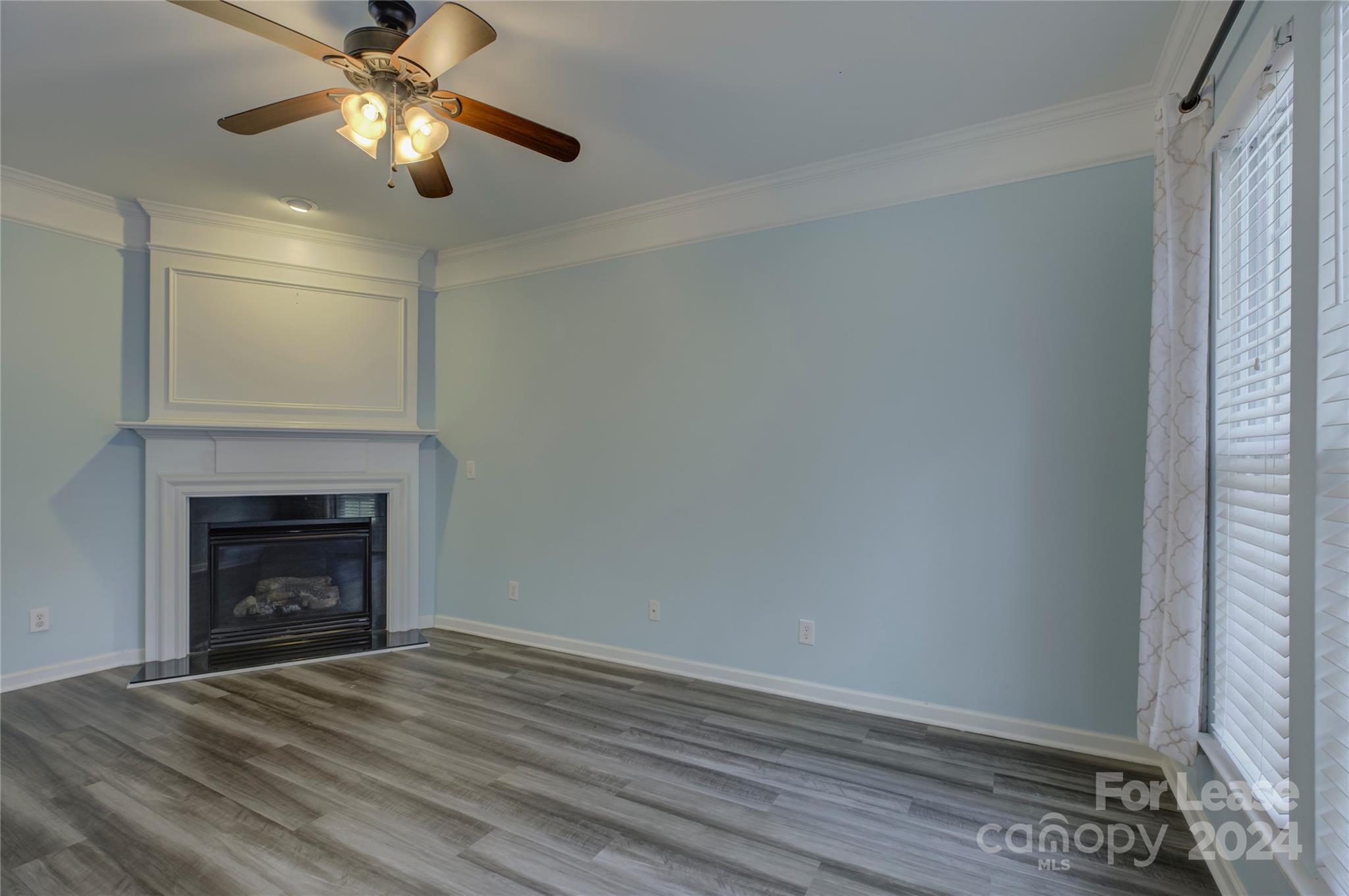 568 6th Baxter Crossing Fort Mill, SC 29708 - Photo 8 of 48 a view of empty room with wooden floor and fireplace