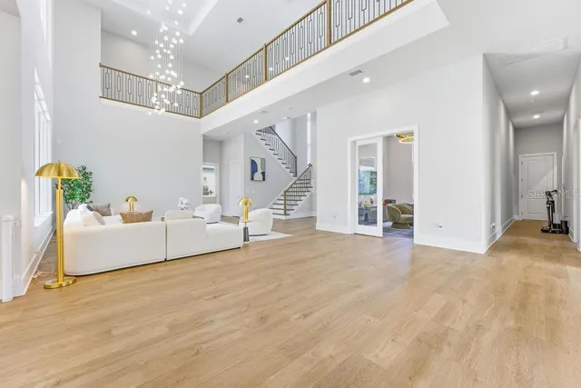 a living room with furniture a large window and a flat screen tv
