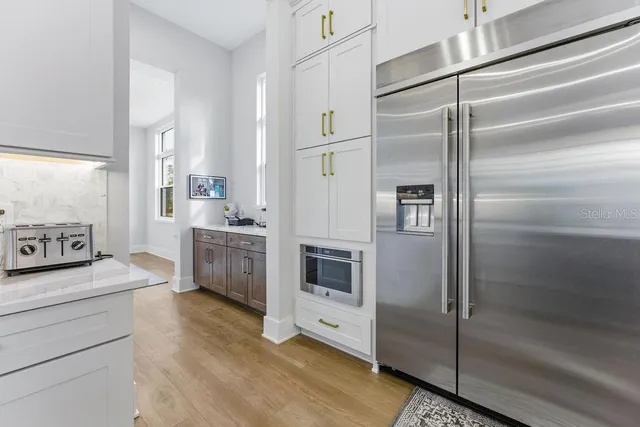 a spacious bathroom with a tub sink and mirror
