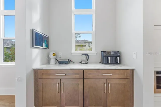 a view of a dining room with furniture and chandelier