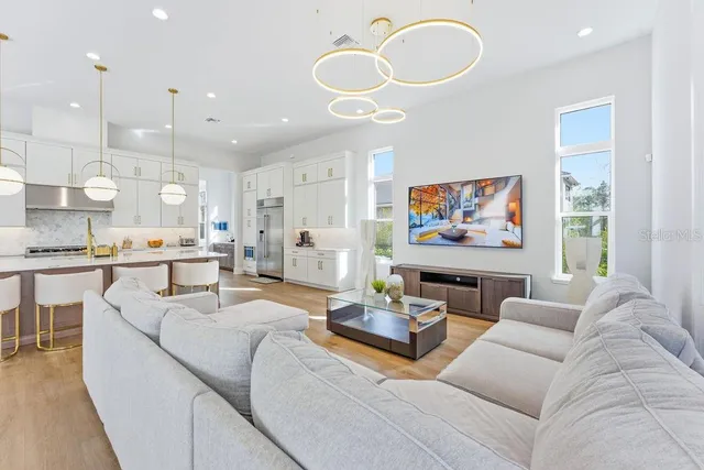 a view of living room with furniture and wooden floor