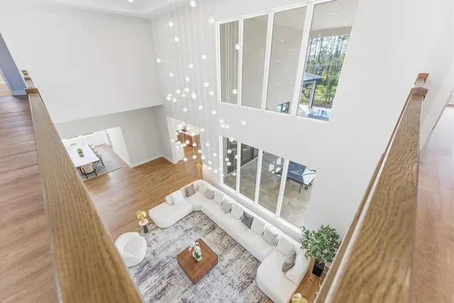 a view of a hallway with wooden floor and staircase