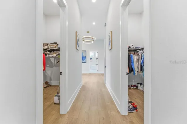 a spacious bedroom with a bed and glass window