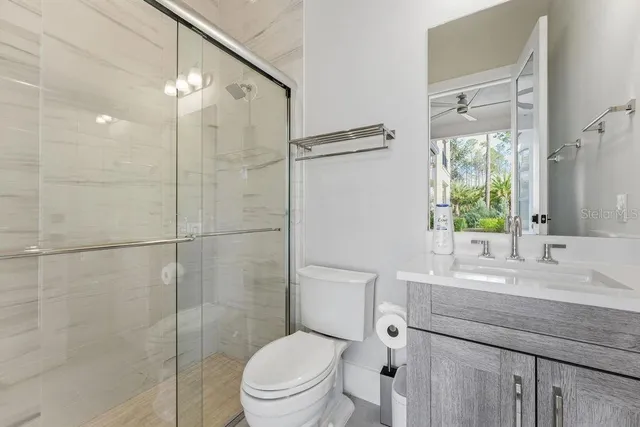 a aerial view of a house with swimming pool and large trees