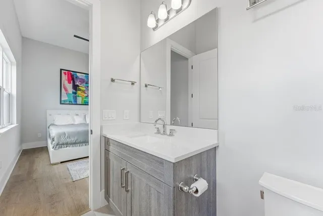 an aerial view of a house with swimming pool and large trees