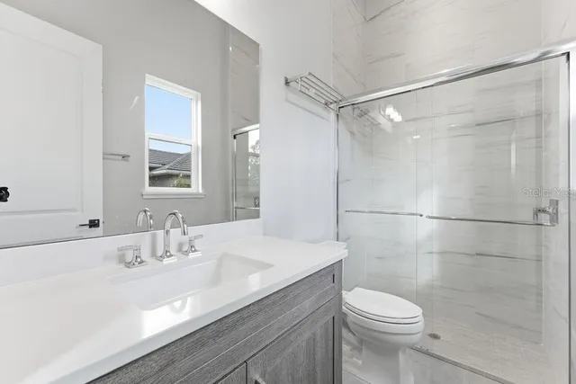 an aerial view of a house with a garden and swimming pool