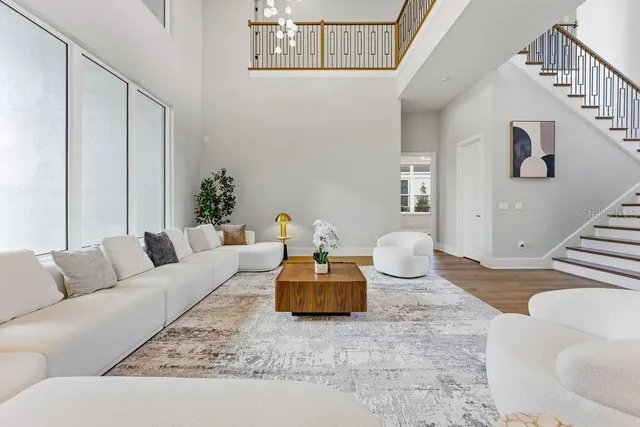 a kitchen with stainless steel appliances granite countertop a sink a stove and a wooden floors