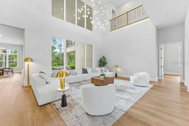 a kitchen with stainless steel appliances a refrigerator a stove and white cabinets