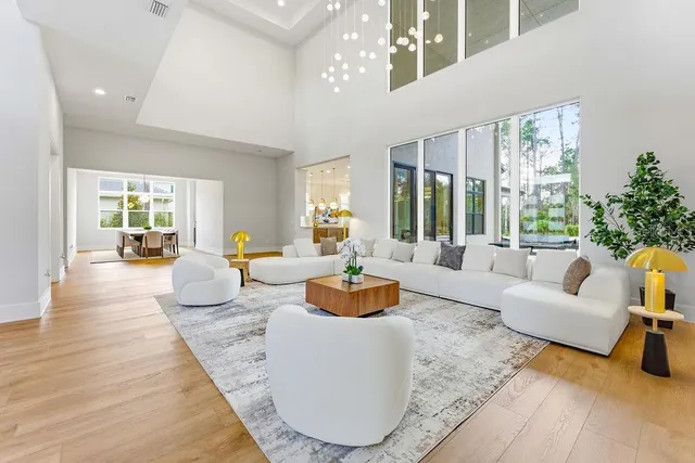 a kitchen with stainless steel appliances granite countertop a sink a stove and a wooden floors