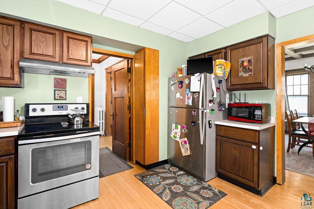 23 5th Street Proctor, MN 55810 - Photo 14 of 32 Kitchen with a paneled ceiling, appliances with stainless steel finishes, and light hardwood / wood-style floors