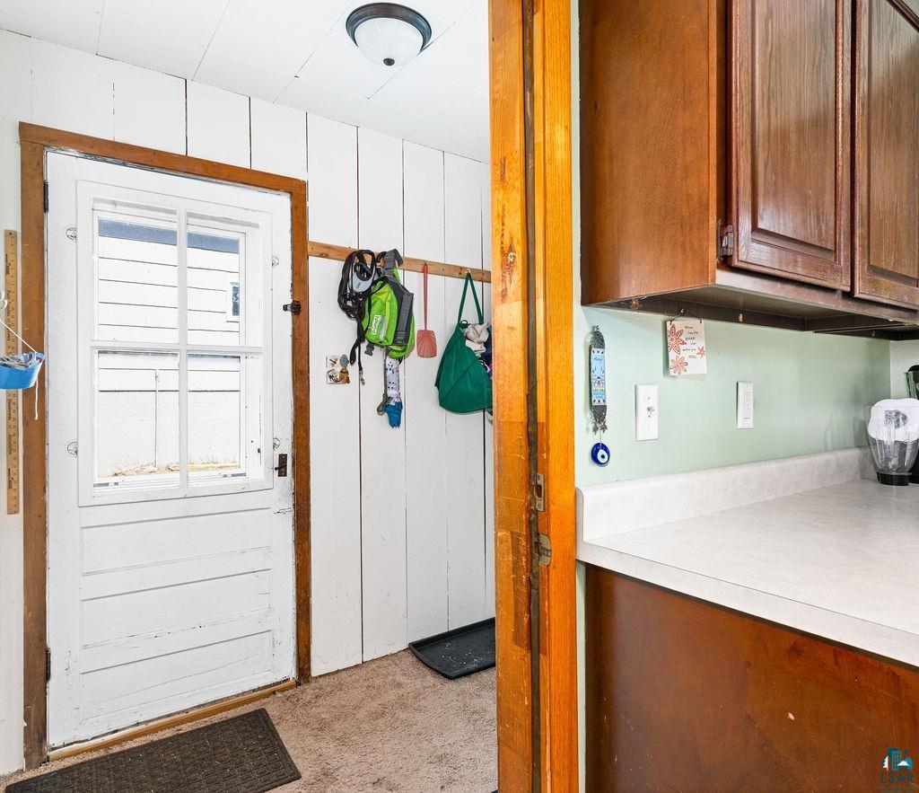 23 5th Street Proctor, MN 55810 - Photo 16 of 32 Doorway featuring wood walls and light colored carpet
