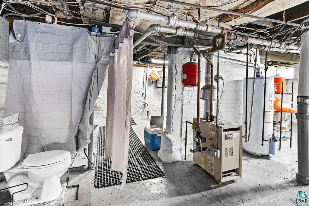 23 5th Street Proctor, MN 55810 - Photo 27 of 32 Interior space featuring toilet, concrete flooring, and water heater