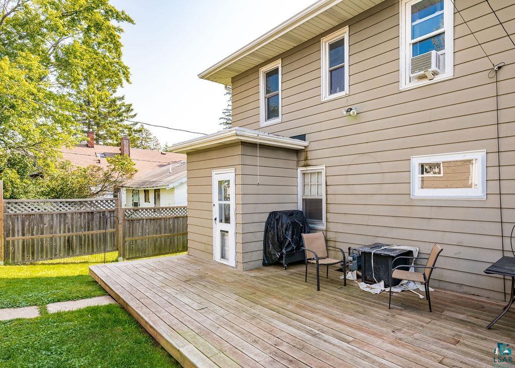 23 5th Street Proctor, MN 55810 - Photo 31 of 32 Wooden deck featuring cooling unit, a yard, and area for grilling