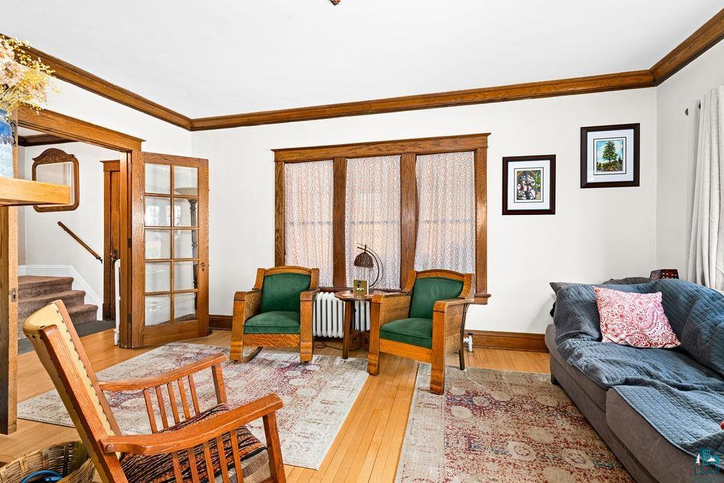 23 5th Street Proctor, MN 55810 - Photo 9 of 32 Living room featuring ornamental molding, hardwood / wood-style floors, and radiator heating unit