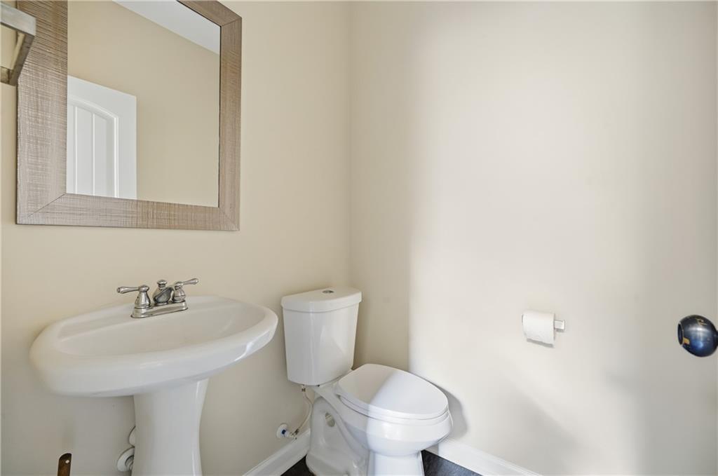 404 Sheila Way Canton, GA 30114 - Photo 12 of 36 a bathroom with a sink a toilet and mirror