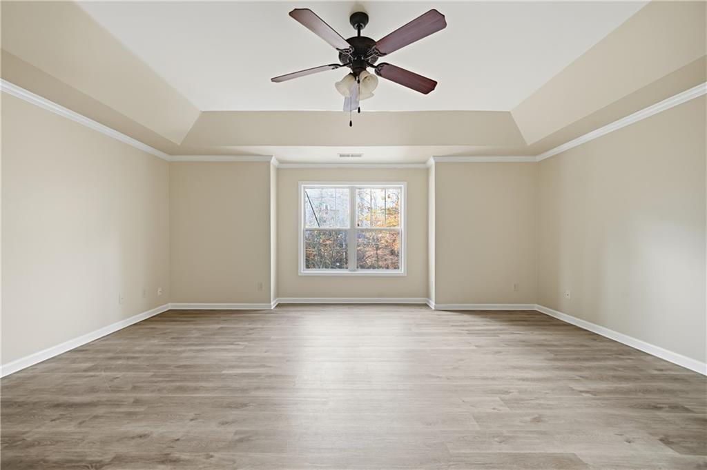 404 Sheila Way Canton, GA 30114 - Photo 13 of 36 an empty room with windows and fan