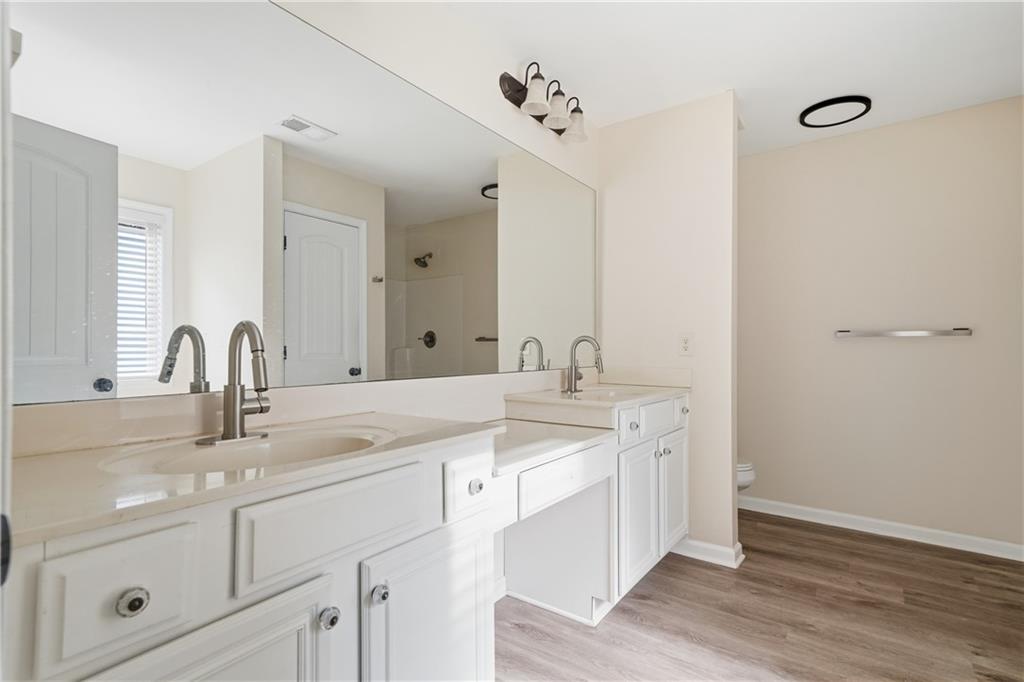 404 Sheila Way Canton, GA 30114 - Photo 16 of 36 a bathroom with double sink and a mirror
