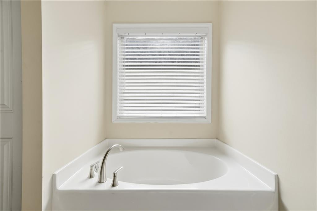 404 Sheila Way Canton, GA 30114 - Photo 19 of 36 a white bath tub sitting next to a window
