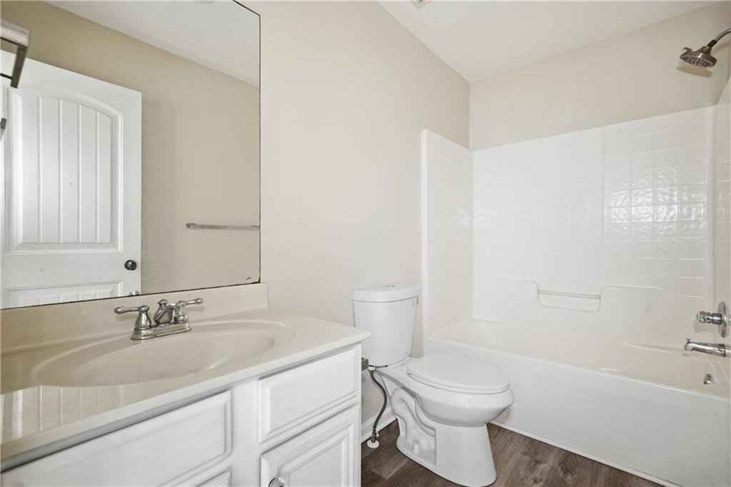 404 Sheila Way Canton, GA 30114 - Photo 20 of 36 a bathroom with a sink a toilet and shower
