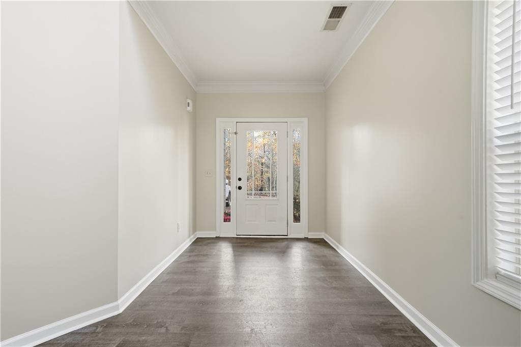 404 Sheila Way Canton, GA 30114 - Photo 2 of 36 an empty room with wooden floor and windows